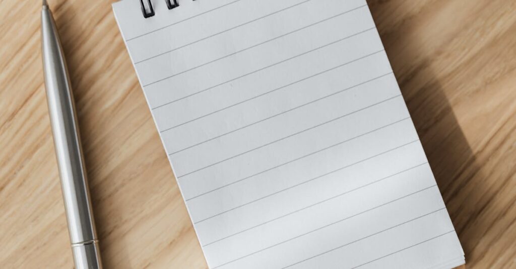 three lined notebook on wooden desk