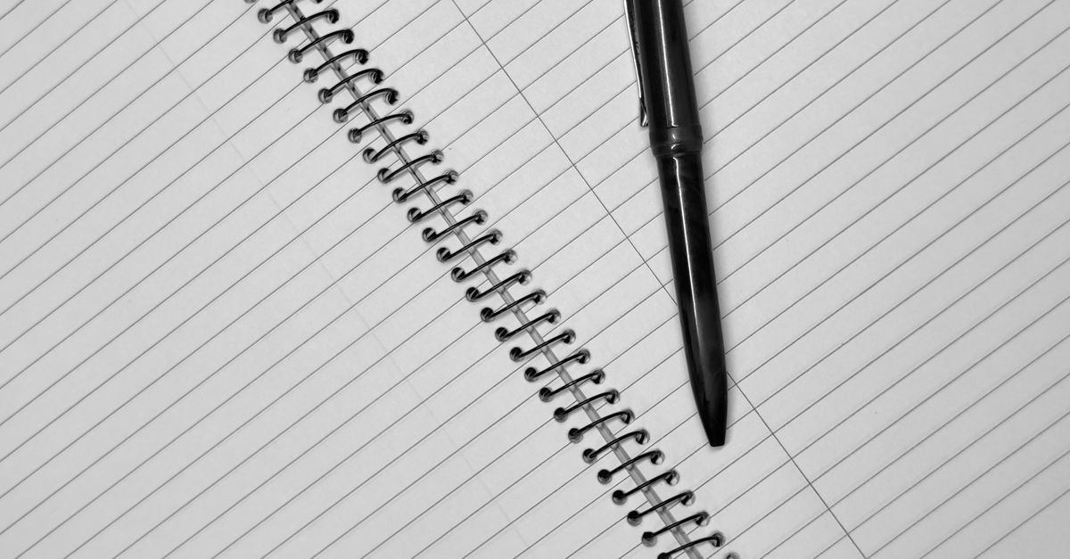 blank notebook with pen