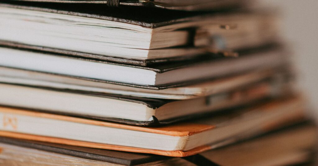 stack of notebooks on desk