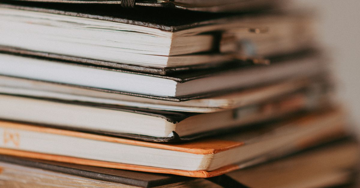 stack of notebooks on desk