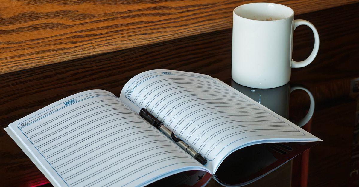 open writing notebook with pen