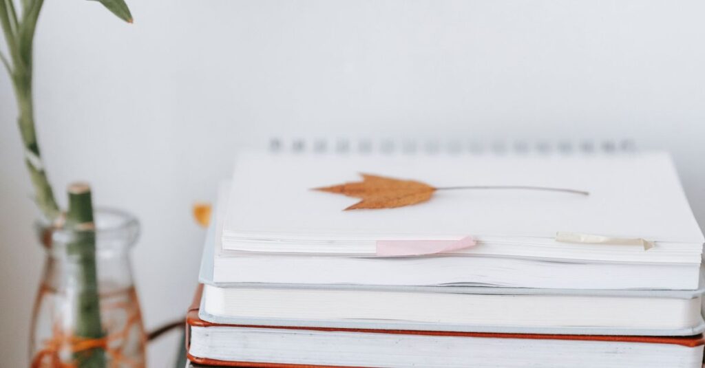 stack of notebooks on desk