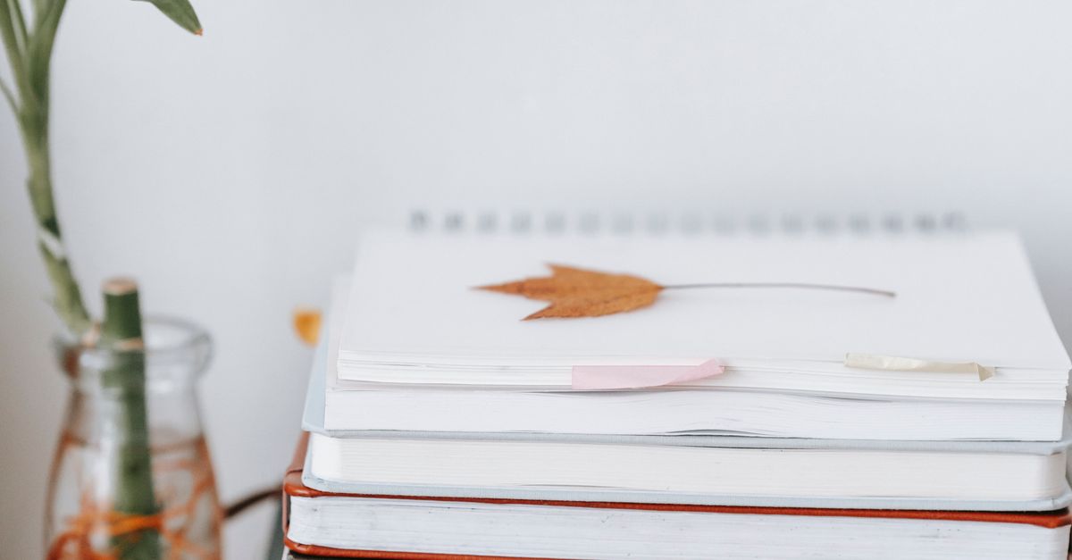 stack of notebooks on desk
