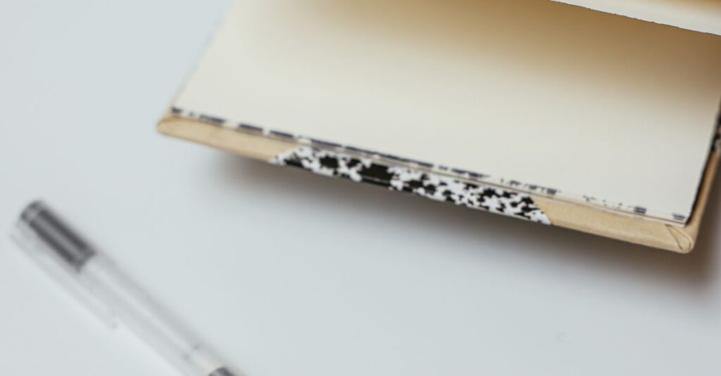 open notebook with pen on desk