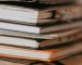 stack of notebooks on desk